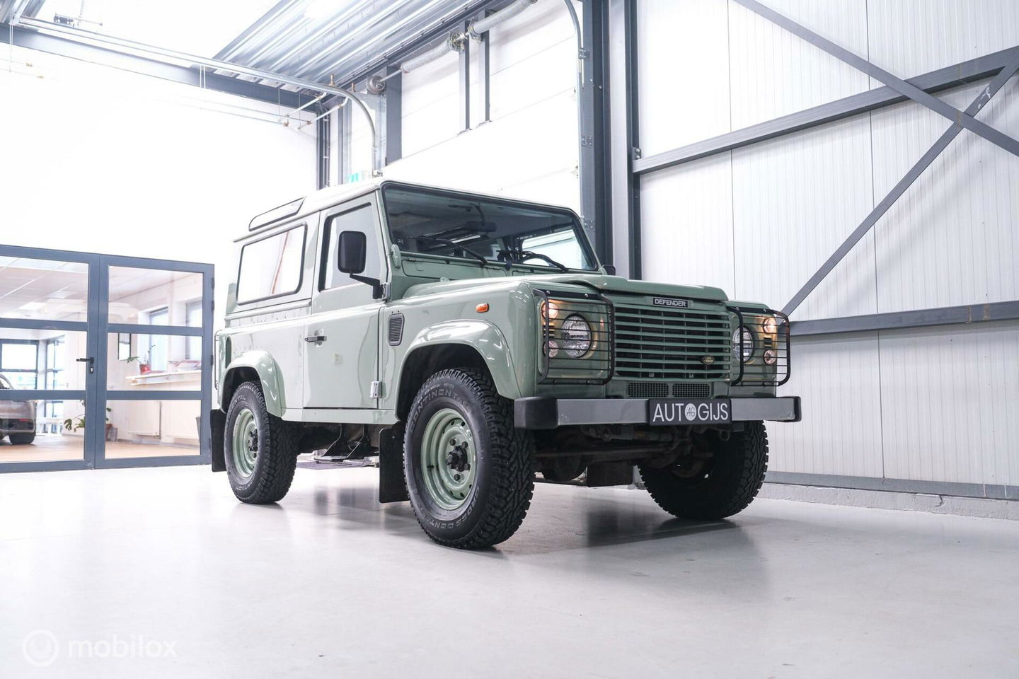 Land Rover Defender 90 2.5 Td5 | HUE 166 | Grasmere Green | Heritage | NL auto NAP | 2e eigenaar | A-Z onderhouden | Unieke auto |