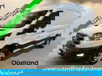 Ford E-Transit - 350 L2H2 Trend 68 kWh / 100% Elektrisch !! / Airco / Cruise Control / CarPlay / Camera / Navigatie / 3-Zits / 12.000 KM !!