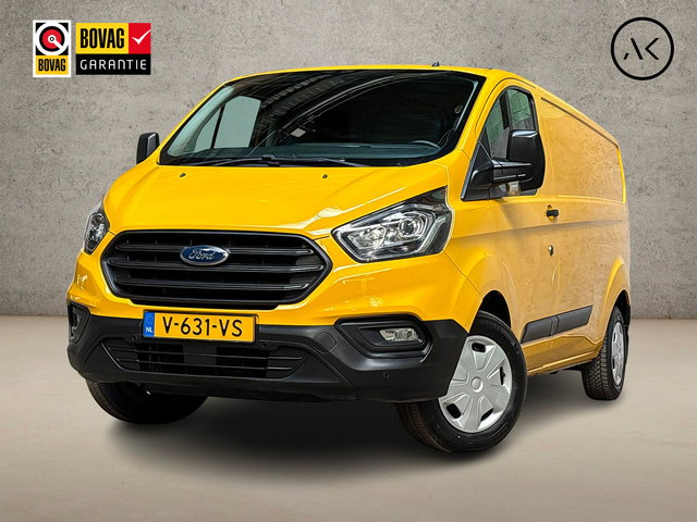 Ford Transit Custom - 320 2.0 TDCI L2H1 Deluxe (STOELVERWARMING, BLUETOOTH, ELEK RAMEN, XENON, PARKEERSENSOREN, ARMSTEUN, TREKHAAK, CRUISE, NIEUWE APK, NIEUWSTAAT)