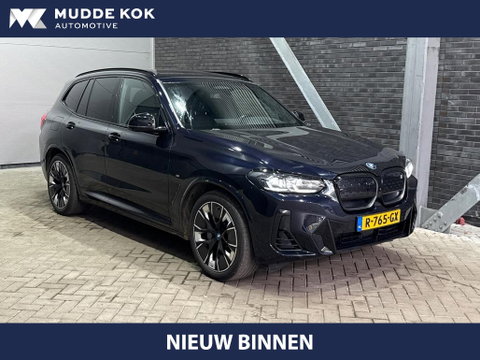 BMW iX3 High Executive 80 kWh | Harman/Kardon | Trekhaak | Head-Up | Parkeerassistent Plus | Adaptief M-onderstel | Stoel+Stuurverwarming | 20 Inch
